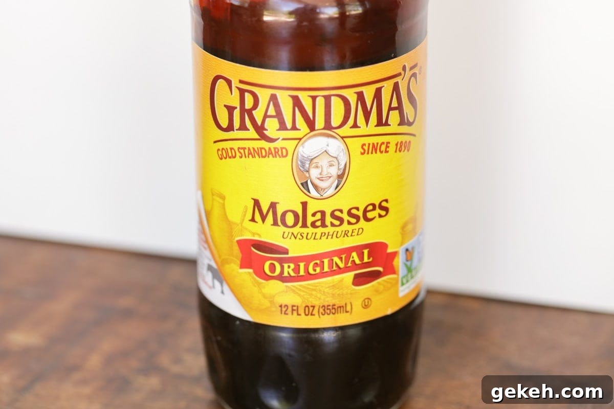 A jar of molasses on a kitchen table.