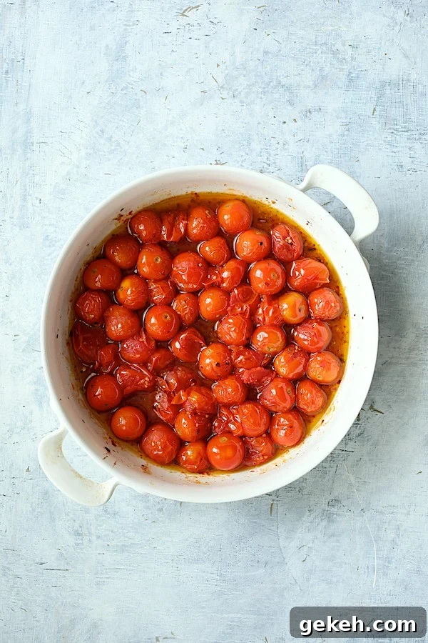 Photo of roasted tomatoes in white baking dish.