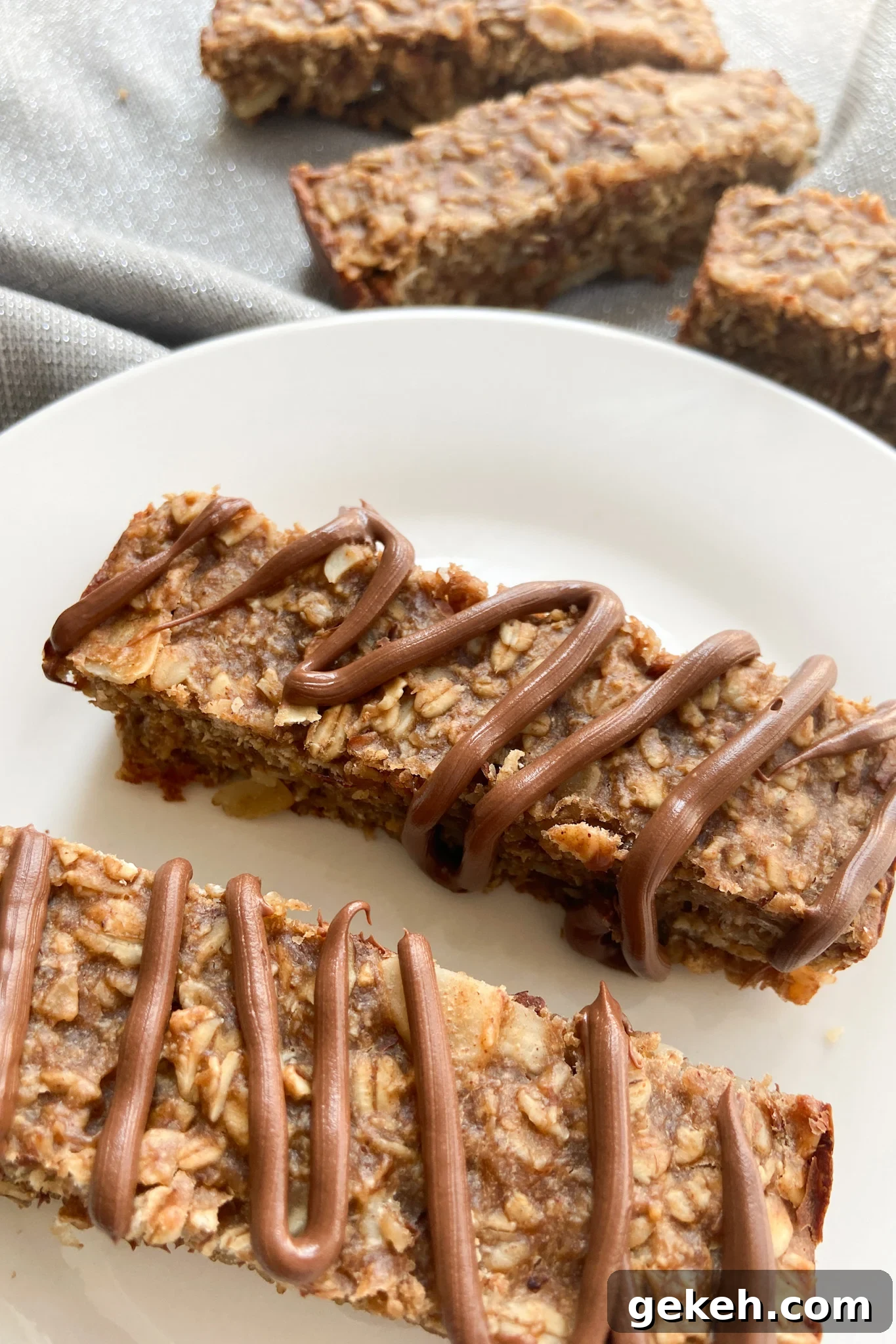 Peanut Butter Banana Granola Bars: Chewy Homemade Snack Recipe 7 Peanut butter and banana granola bars, two served with a drizzle of chocolate on top