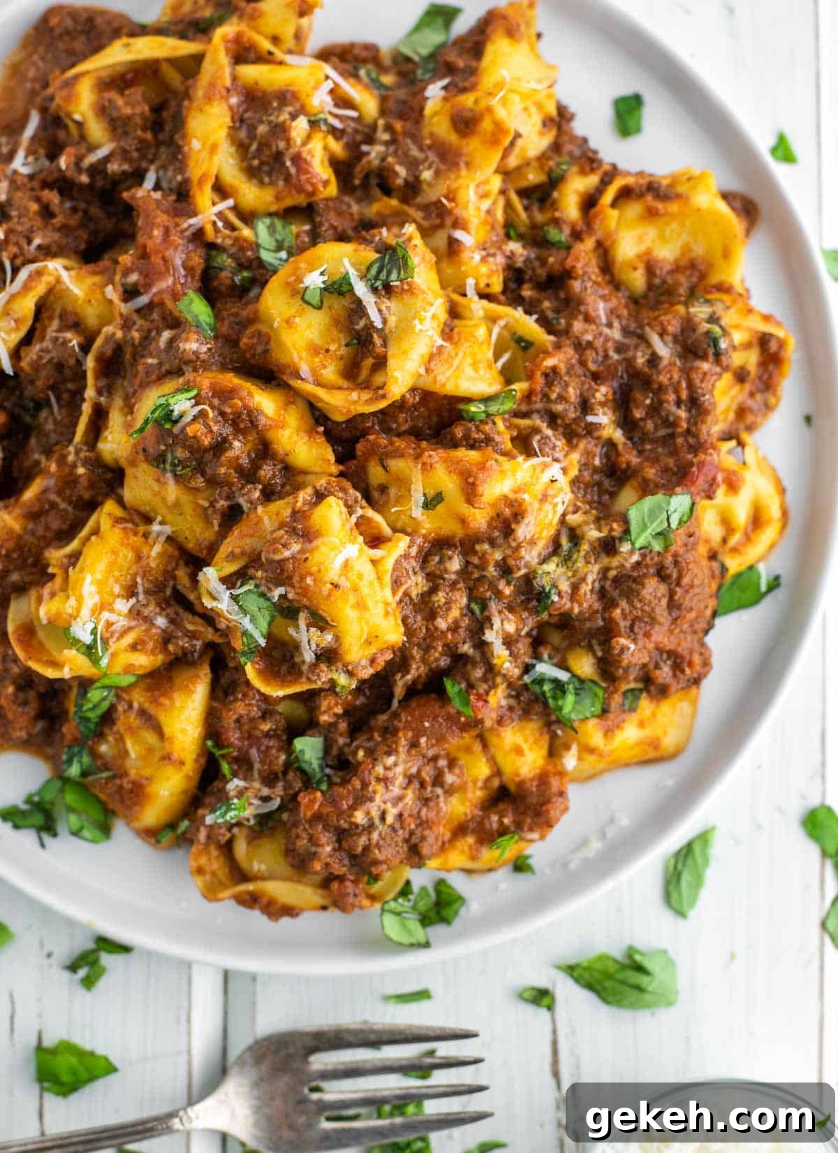 Tortellini Bolognese Recipe: Creamy Meat Sauce Pasta in 30 Minutes 2 overhead shot of bolognese with tortellini on white plate