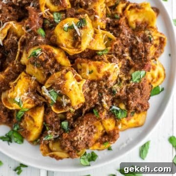 Tortellini Bolognese Recipe: Creamy Meat Sauce Pasta in 30 Minutes 8 overhead shot of bolognese with tortellini on white plate