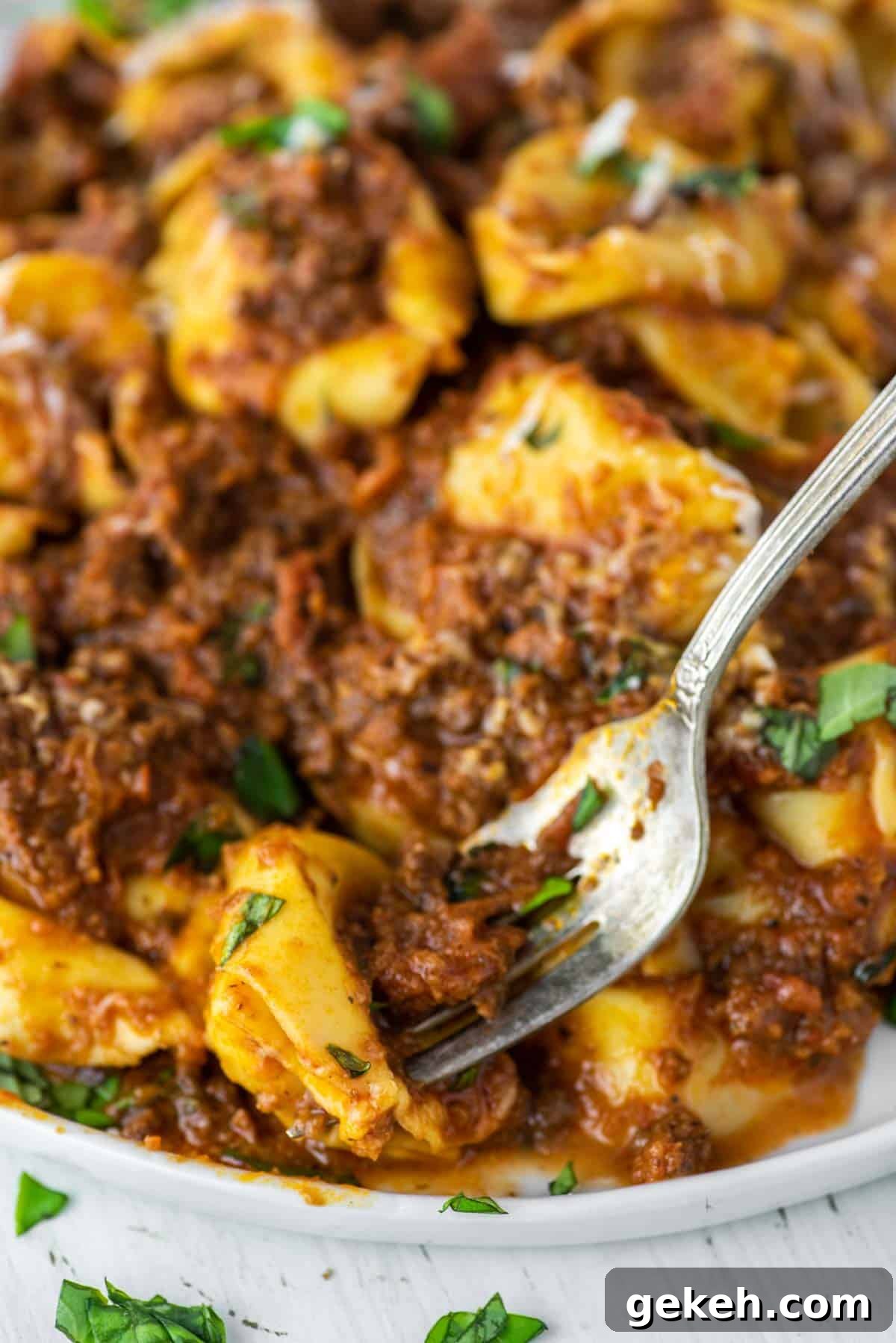 Tortellini Bolognese Recipe: Creamy Meat Sauce Pasta in 30 Minutes 7 fork picking up tortellini from plate