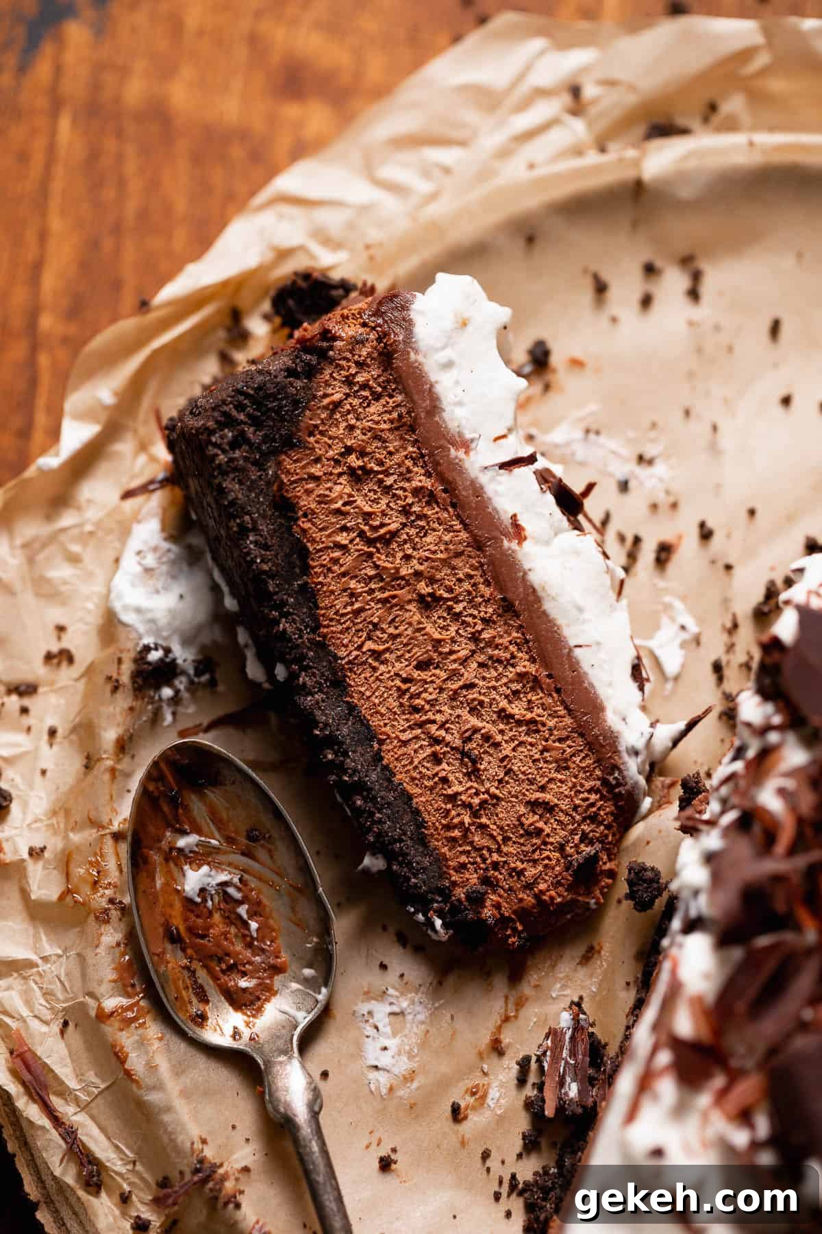 Decadent Dark Chocolate Mousse Pie Recipe for Chocolate Lovers 11 A slice of mousse pie with oreo crust on brown parchment paper
