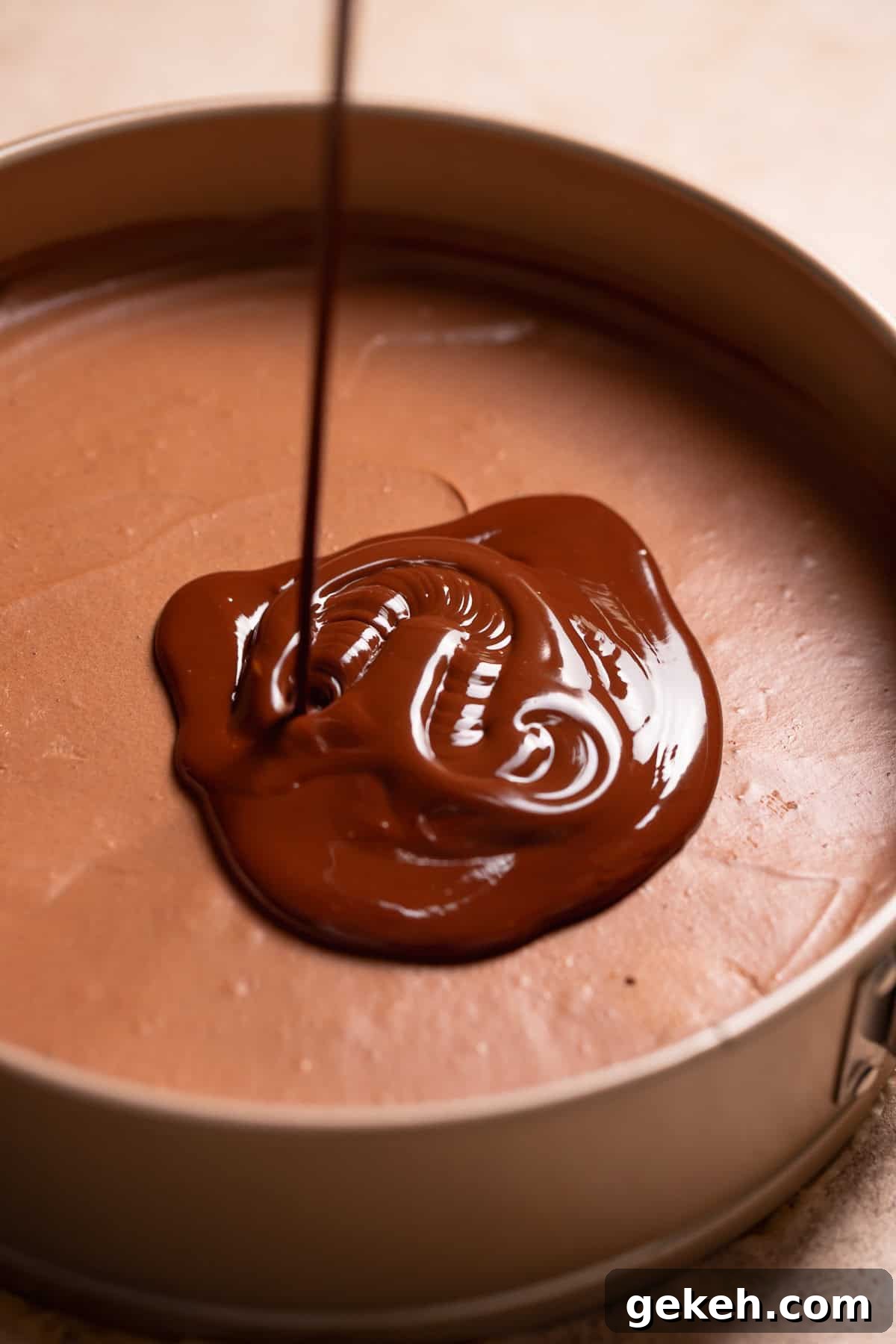 Decadent Dark Chocolate Mousse Pie Recipe for Chocolate Lovers 9 Chocolate ganache being poured over the top of the set mousse filling.