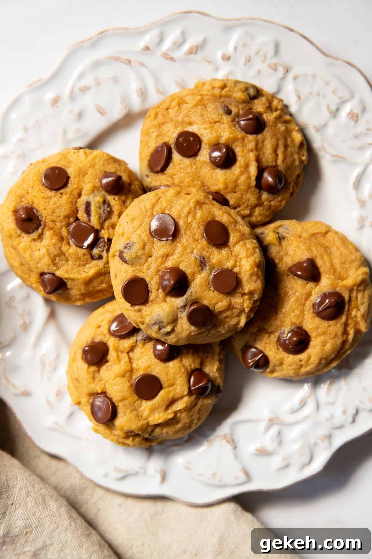 a plate with five soft pumpkin chocolate chip cookies