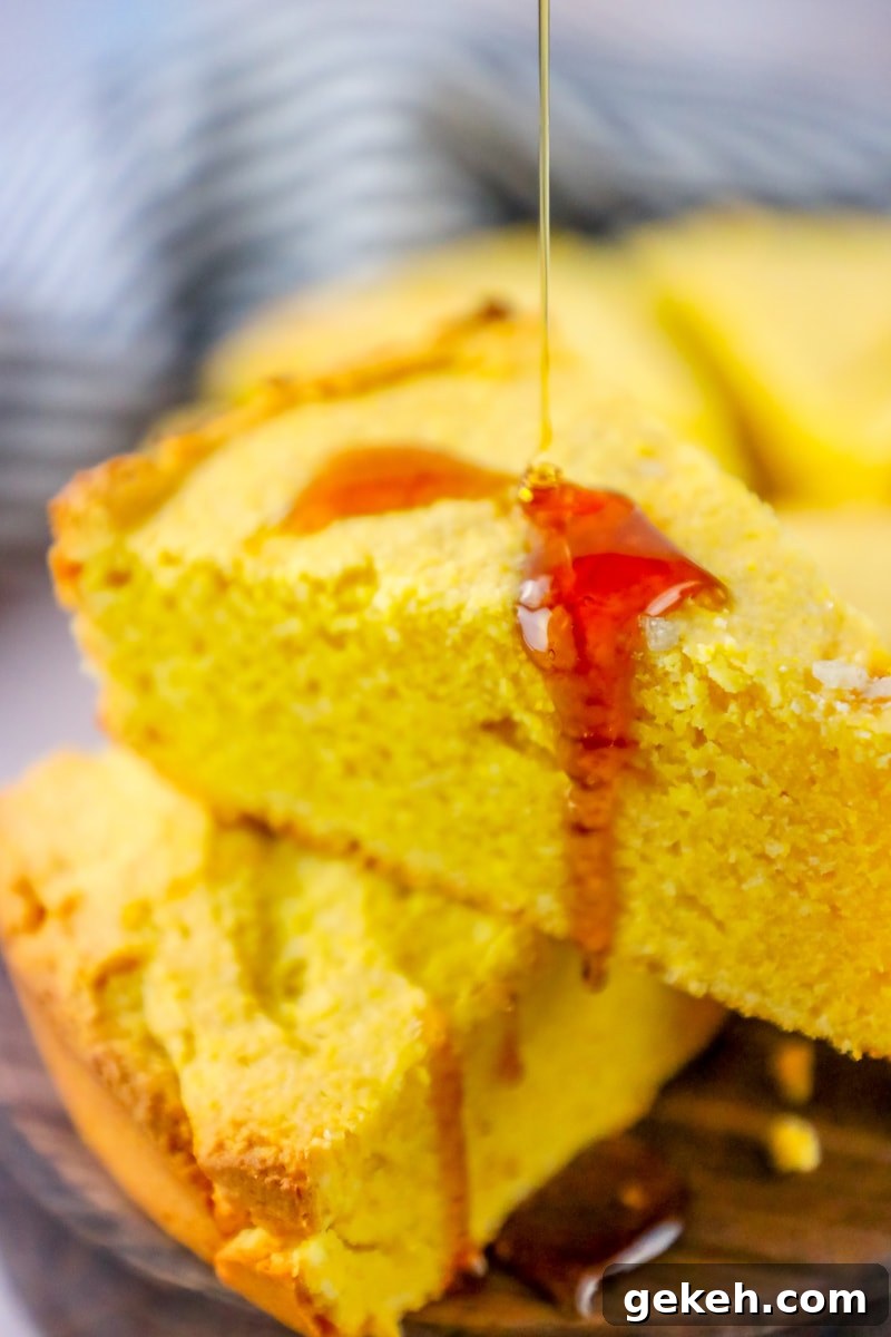 Sour Cream Cornbread Recipe: Moist Southern-Style Loaf 2 cornbread with honey pouring onto it