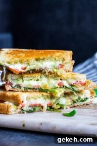 Stacked grilled goat cheese sandwiches. Straight on shot of stacked grilled cheese sandwiches with a dark blue background.