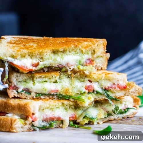 Grilled Goat Cheese Sandwich with Pesto and Arugula 3 Goat cheese sandwich on a white cutting board.