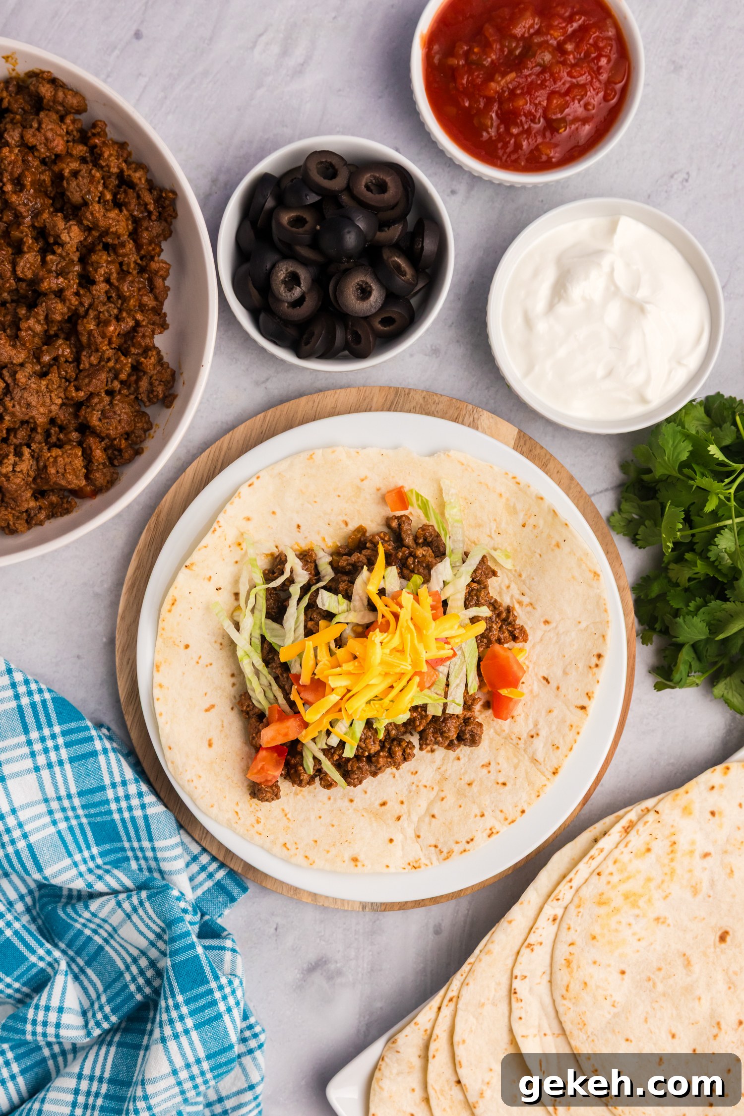 Blackstone Taco Recipe: Crispy Griddle Tacos with Charred Veggies 7 Raw ground beef sizzling on a hot griddle, beginning to brown as it cooks.