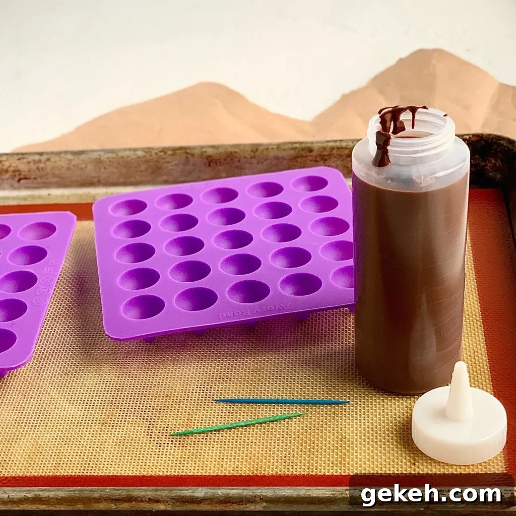 Homemade Chocolate Kisses: Simple Recipe for Melt-in-Your-Mouth Treats 3 melted chocolate in a bottle next to chocolate kiss molds