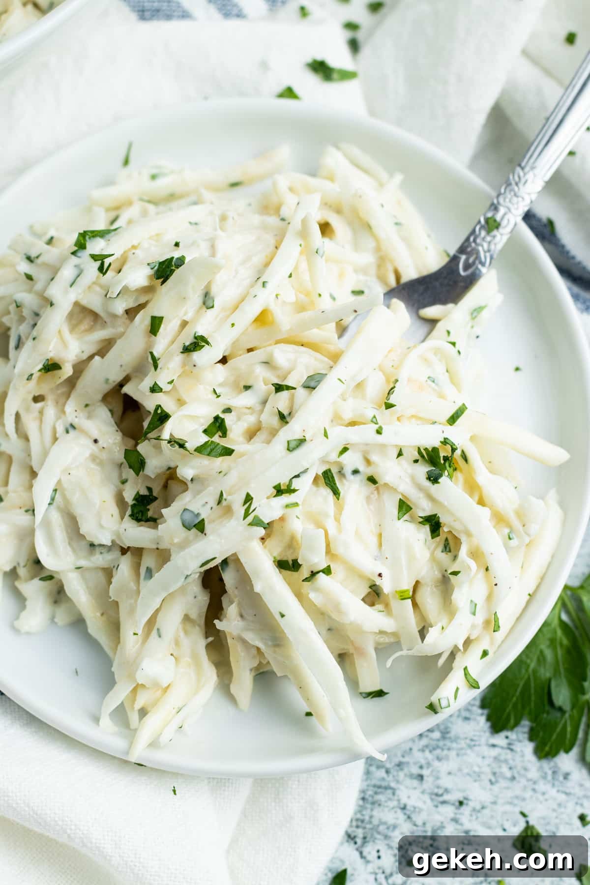 Plate of celery remoulade with a fork.