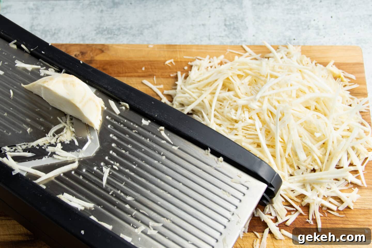 Picture of the celeriac being cut in julienne sticks on the mandoline.