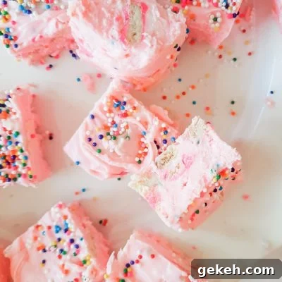 Funfetti Strawberry Fudge Recipe — Colorful No-Bake Treat 7 Over head image of a few strawberry fudge bars with sprinkles and cookies