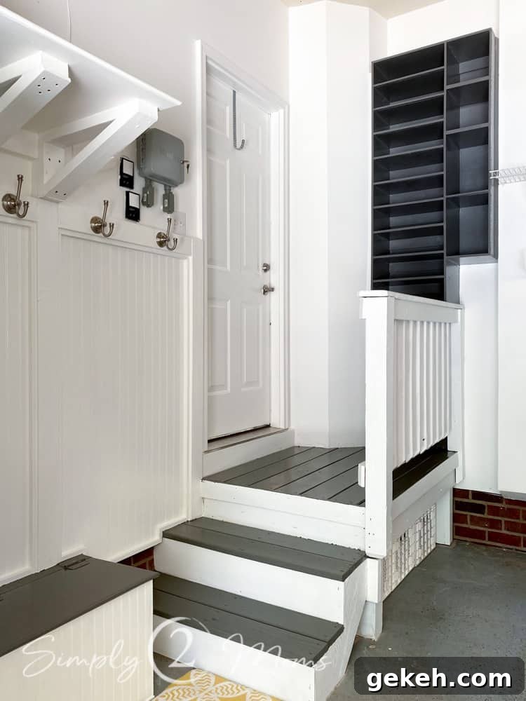 Garage drop zone with built in bench and shoe storage shelving.