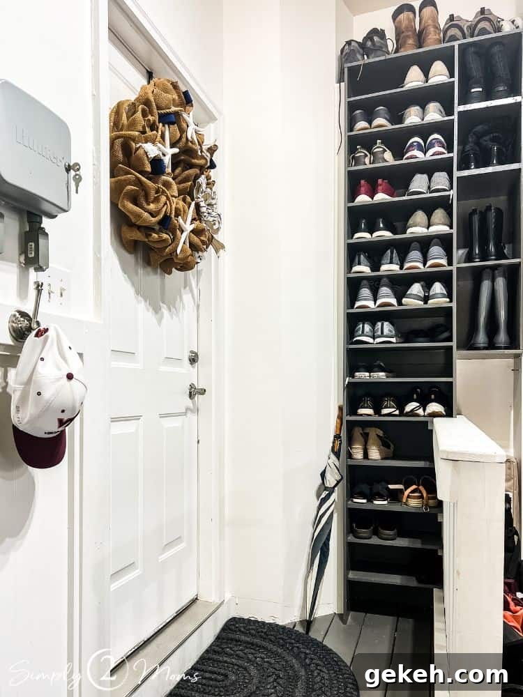 DIY shoe shelves built in on a wall in a garage landing next to the entrance door for the house.