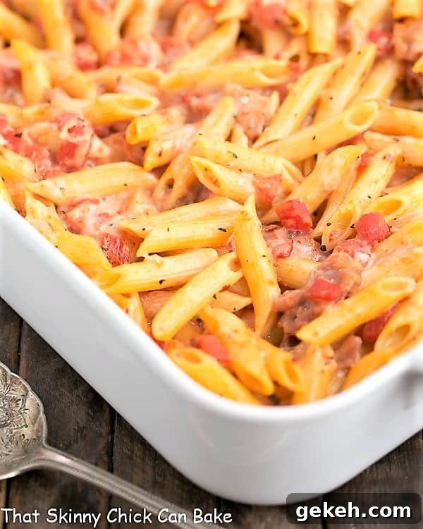 Cheesy Baked Pasta - Creamy pasta with 3 cheeses, basil and prosciutto Cheesy Baked Pasta in a large white casserole dish