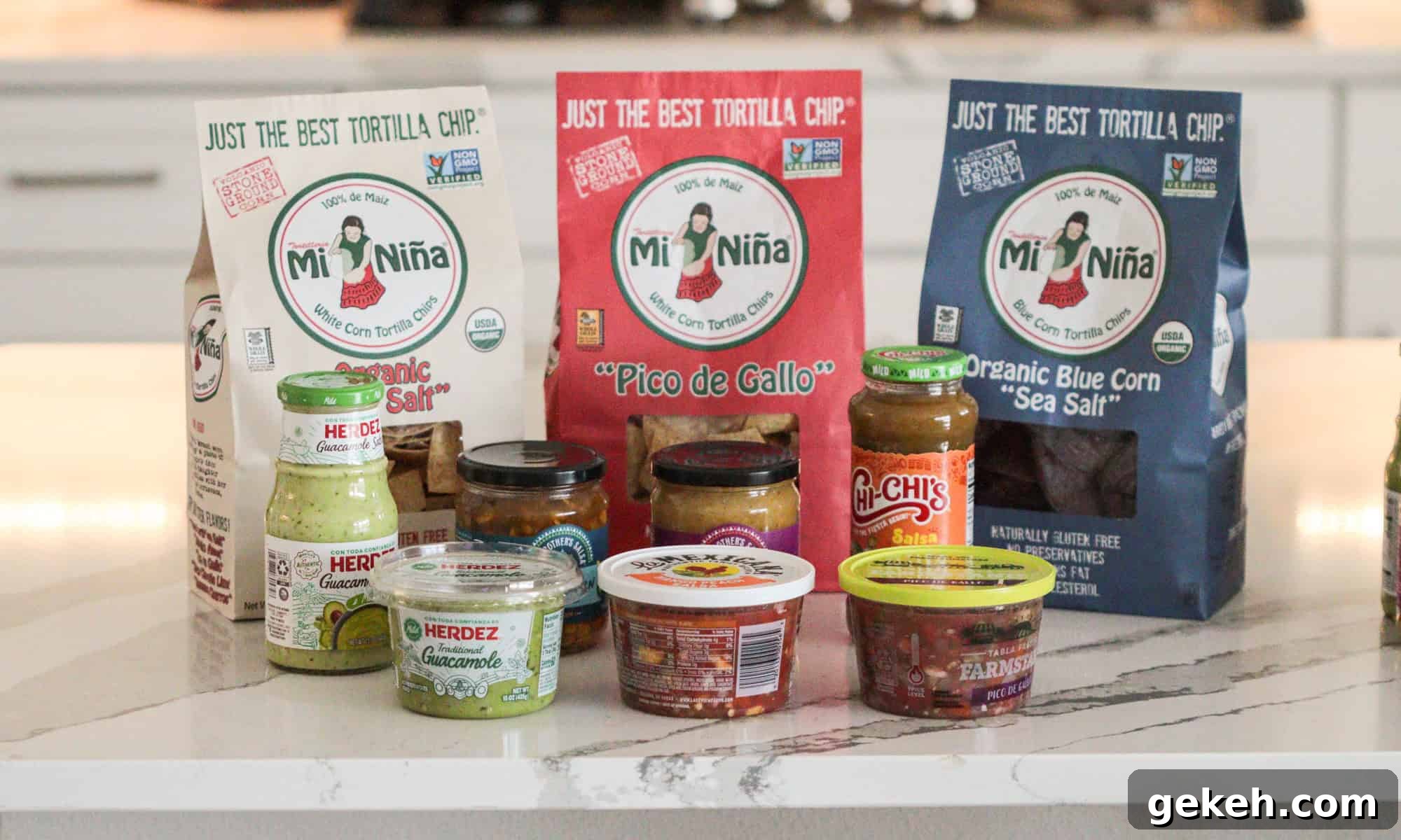 Tortilla chips and salsa jars on table.