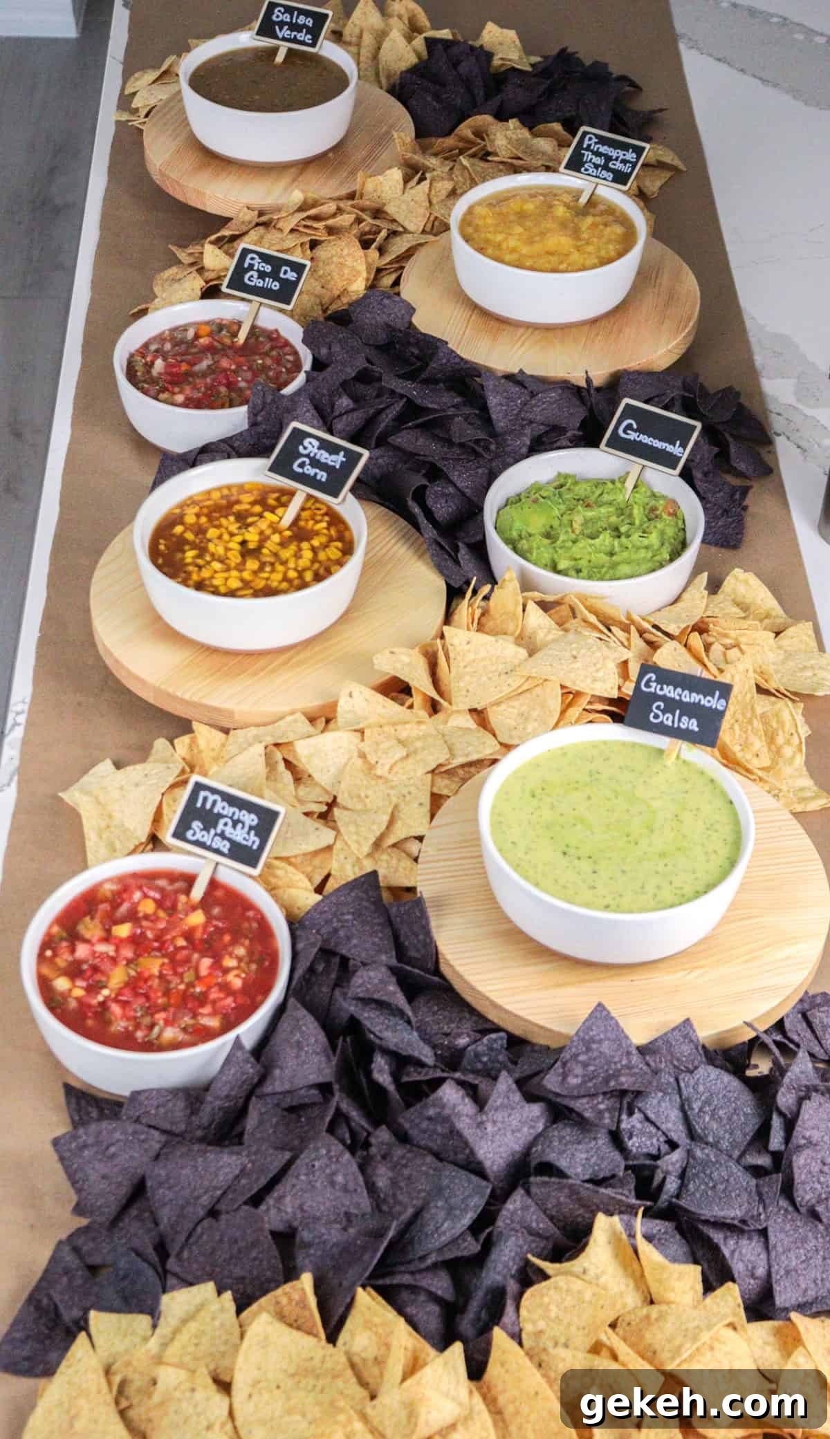 Chips and salsa laid out on table with signs.