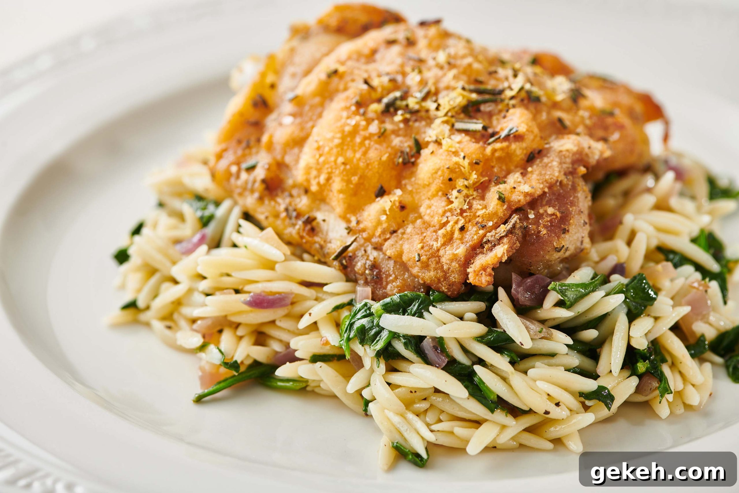 Cooking with Rosemary: Flavorful Recipes and Tips for Home Cooks 3 Lemon Rosemary Chicken and rice pilaf on white plate.