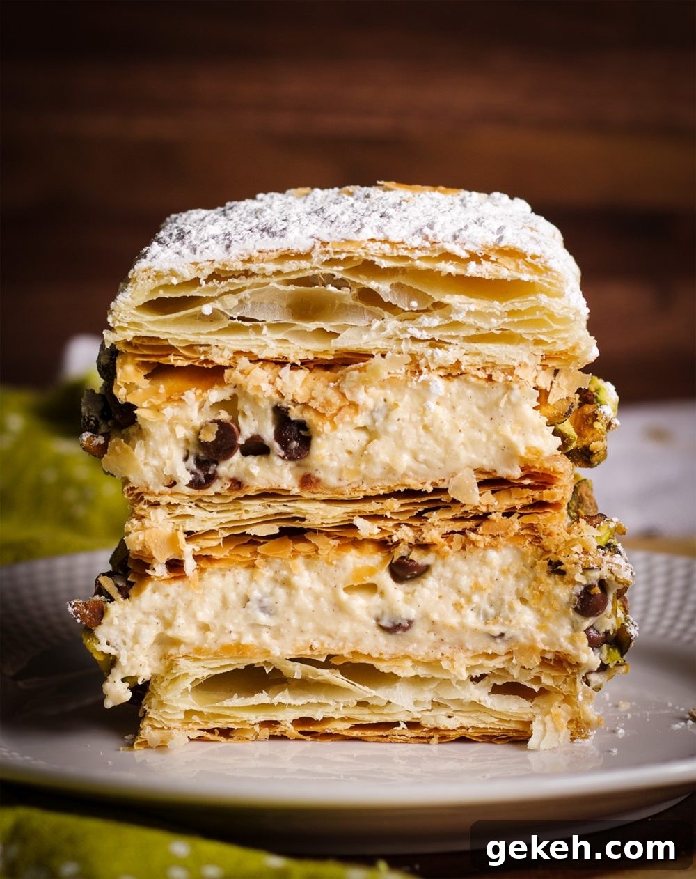 A slice of Cannoli Napoleon on a plate, ready to eat.