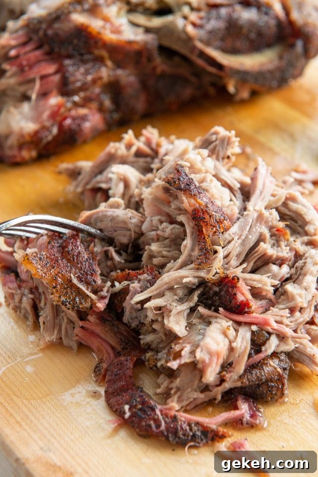 Smoked Pork Butt - Shredded on a Wooden Board with Fork