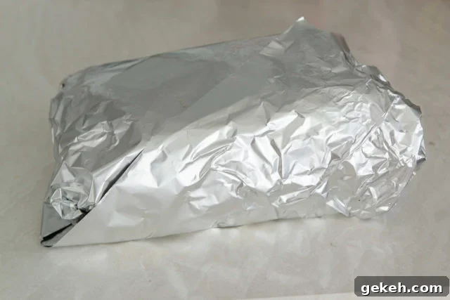 The Meat Completely Wrapped in Aluminum Foil for the Final Cook