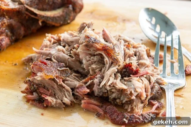 Smoked Pulled Pork - On a Wooden Board with Serving Fork