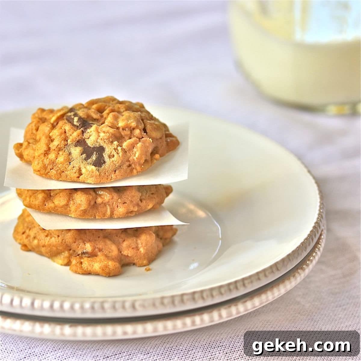 Peanut Butter-Oatmeal Cookies With Coconut Oil : The Wimpy Vegetarian Three peanut butter, oatmeal cookies with chocolate chips stacked on top of each other on a plate.