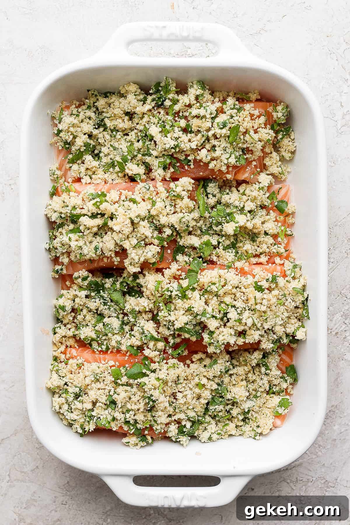 Crispy Panko-Crusted Salmon with Lemon Garlic Butter 4 Four salmon fillets in a casserole dish topped with the panko seasoning mixture.