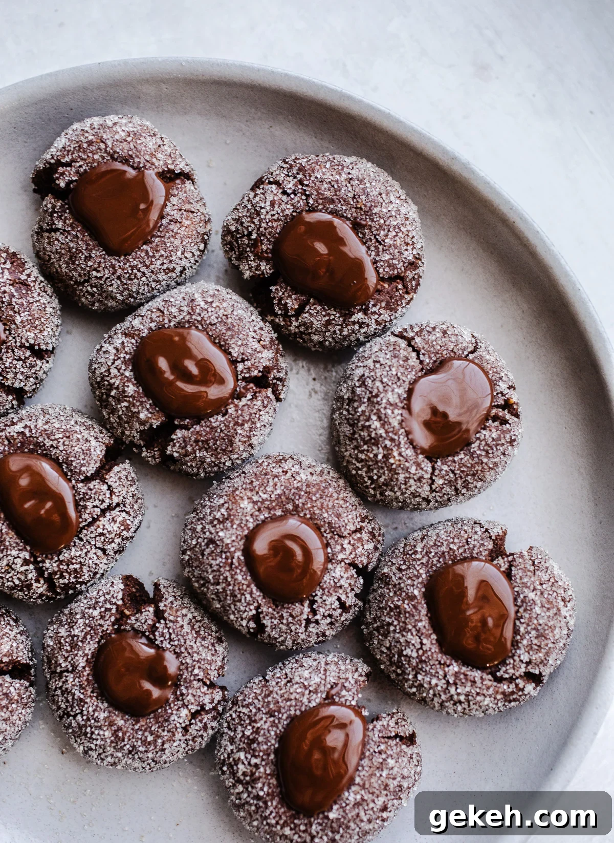 Gluten-Free Chocolate Blossom Cookies Recipe for Perfect Bakes 8 Cookies with chocolate centers on a plate.