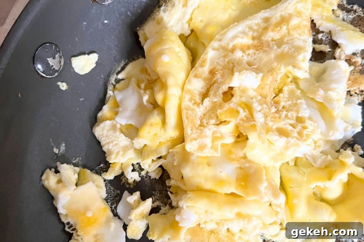 Scrambled eggs in frying pan. 