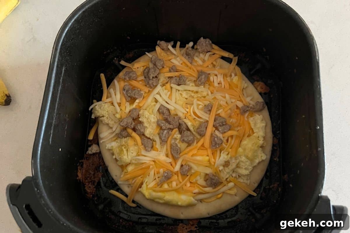 Breakfast pizza in air fryer basket. 