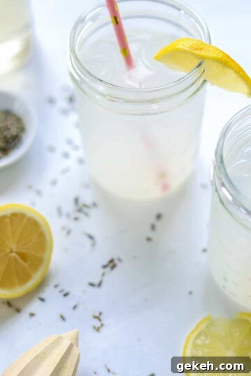 two ball jars filled with lavender lemonade and pink straws