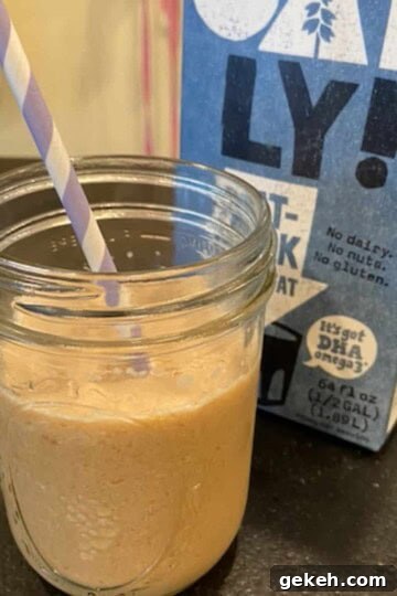 oat milk latte in mason jar with oat-ly! oat-milk in background
