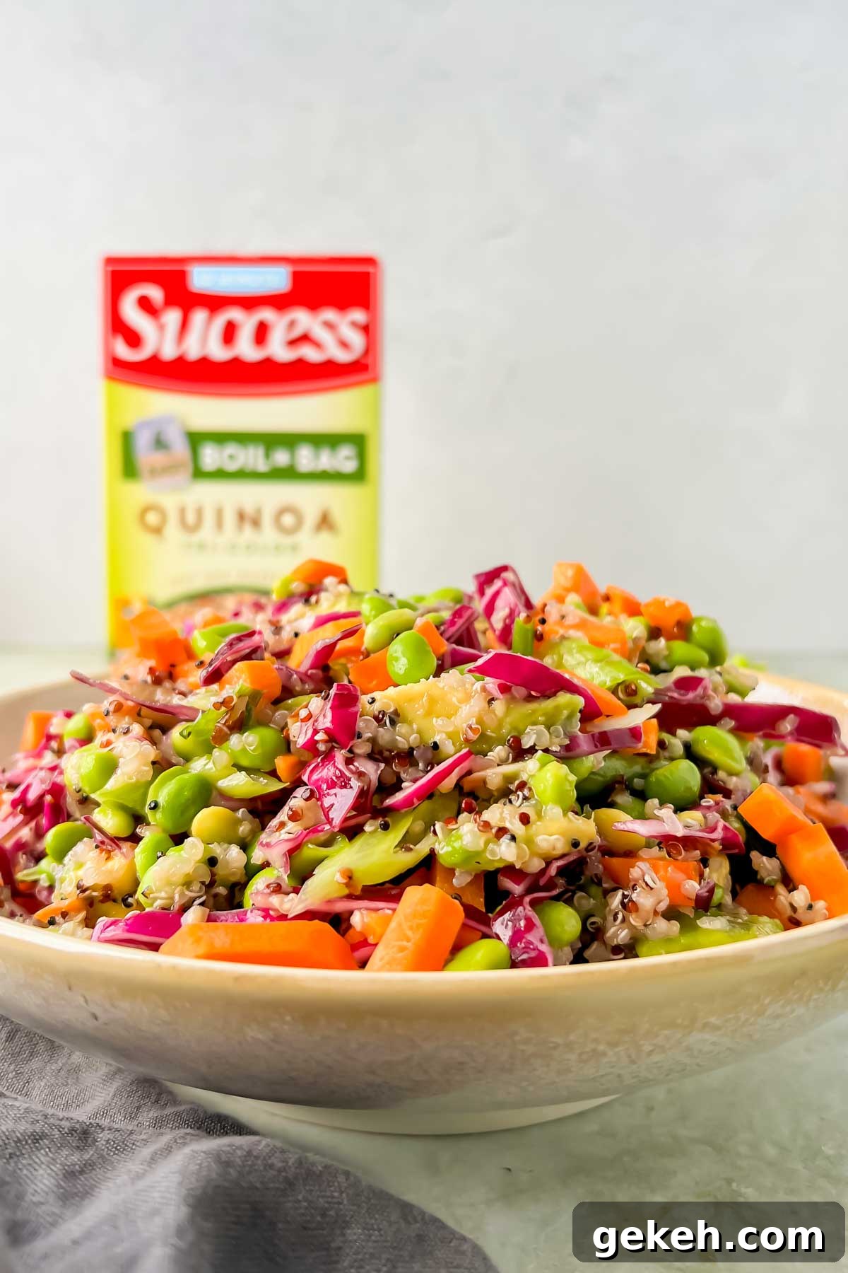 close up view of Quinoa Edamame salad with Success Rice packaging in background.