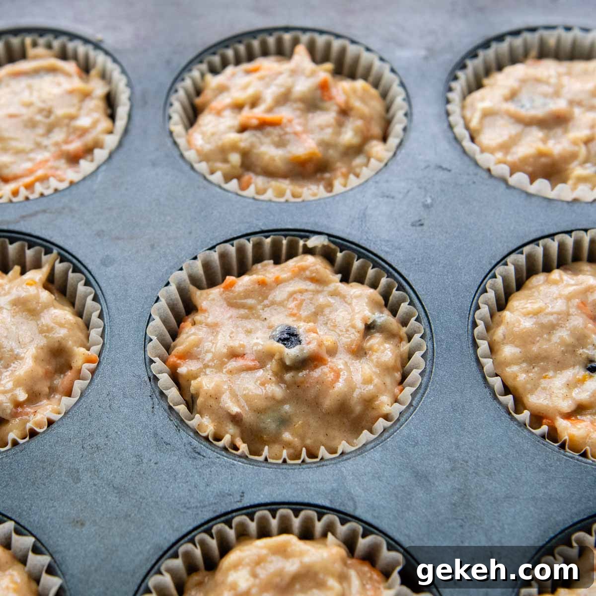 a muffin tin with filled with unbaked batter.