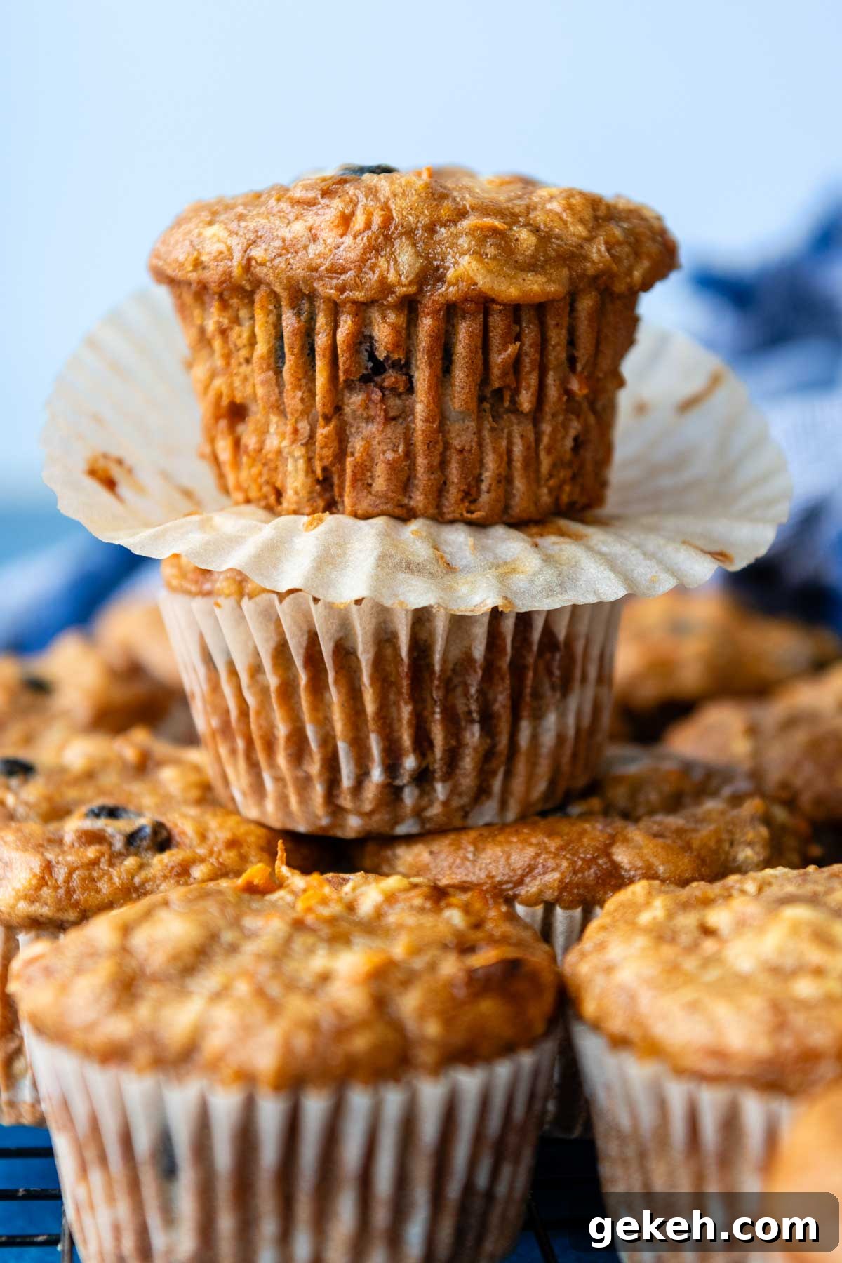 a stack of two carrot muffins with the paper taken off.