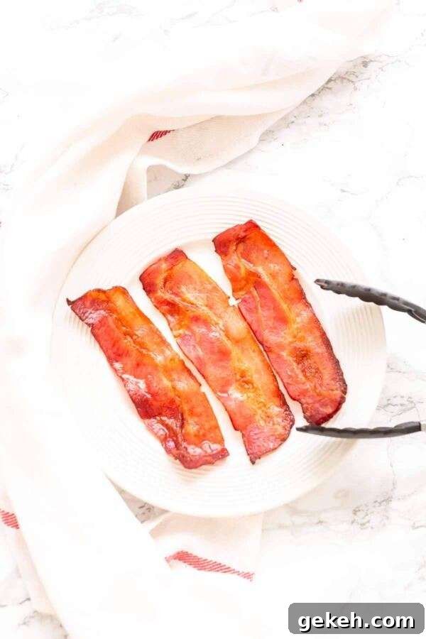 The easiest way to prepare bacon is Air Fryer Bacon. Done in no time. The ultimate set and forget recipe to get amazing bacon for all your recipes. Try it and you will never make bacon any other way. No smoke, less fat and crispy, crunchy bacon.