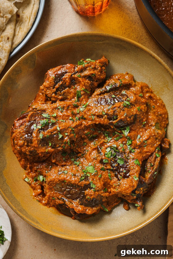 Bagara Baingan: Authentic South Indian Eggplant Curry Recipe 15 Close up of Bagare Baingan in a plate garnished with minced cilantro.