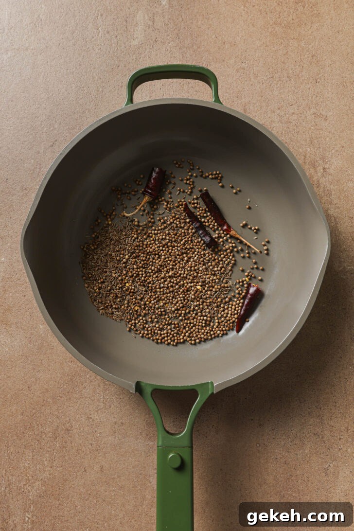 Bagara Baingan: Authentic South Indian Eggplant Curry Recipe 7 Toasting whole spices in a skillet to make Bagare Baingan.