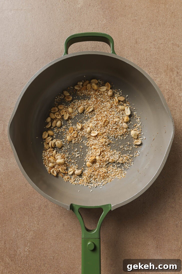 Bagara Baingan: Authentic South Indian Eggplant Curry Recipe 9 Coconut, poppy seeds and sesame seeds added to skillet with toasted peanuts.
