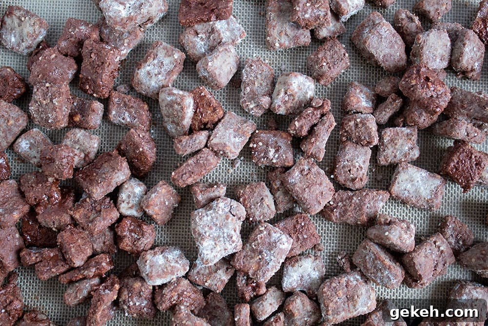 Keto Puppy Chow Recipe: Low-Carb Muddy Buddies Snack 3 overhead view of keto puppy chow spread out on a baking sheet