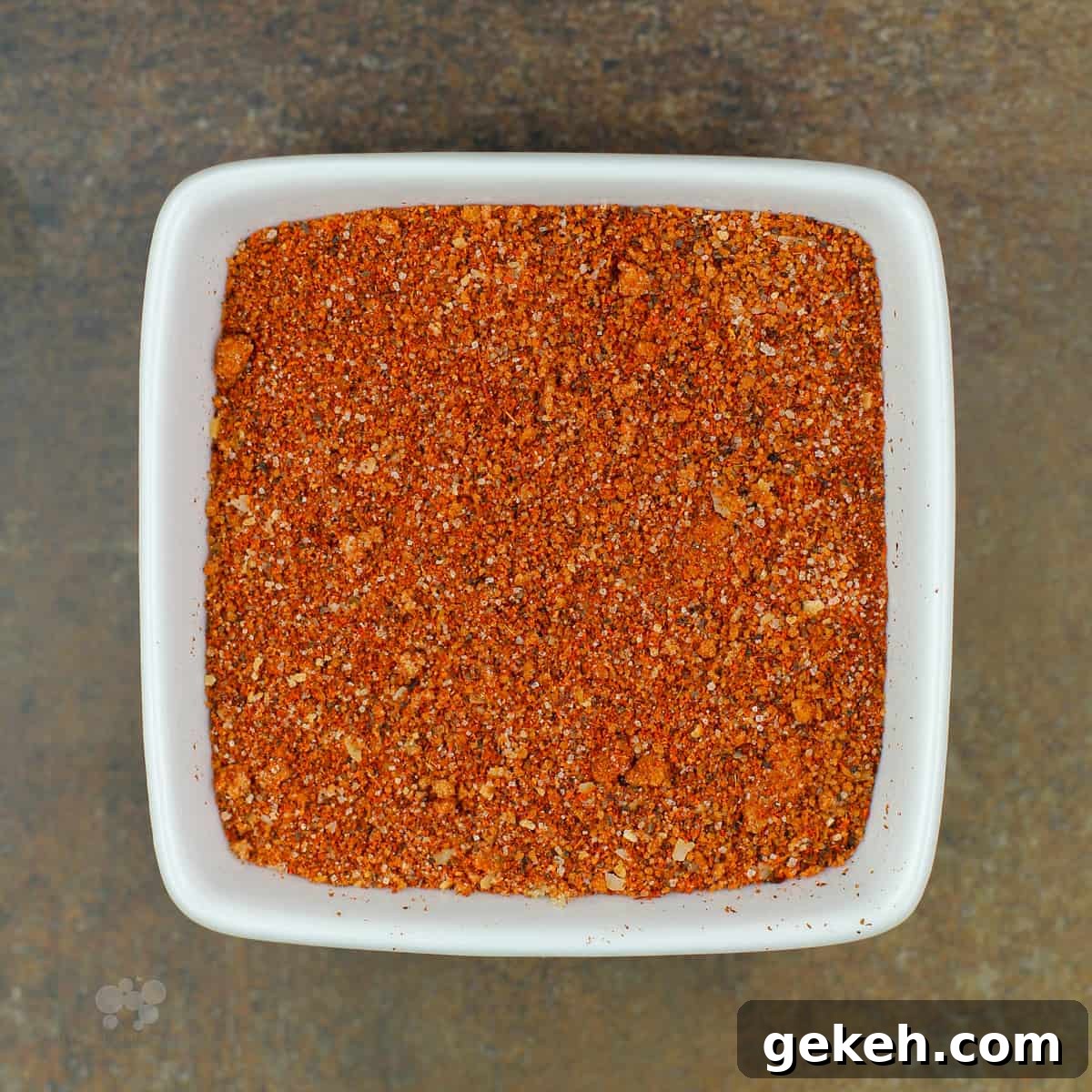 grill rub in square white bowl on brown background.
