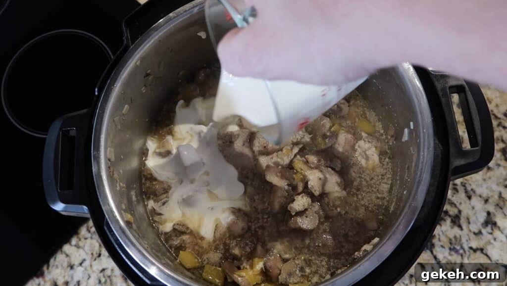Adding cream to chicken in pot