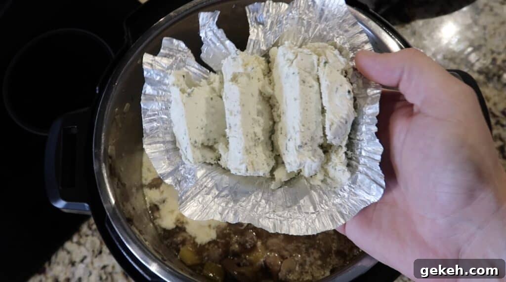 Adding herb cheese to pot