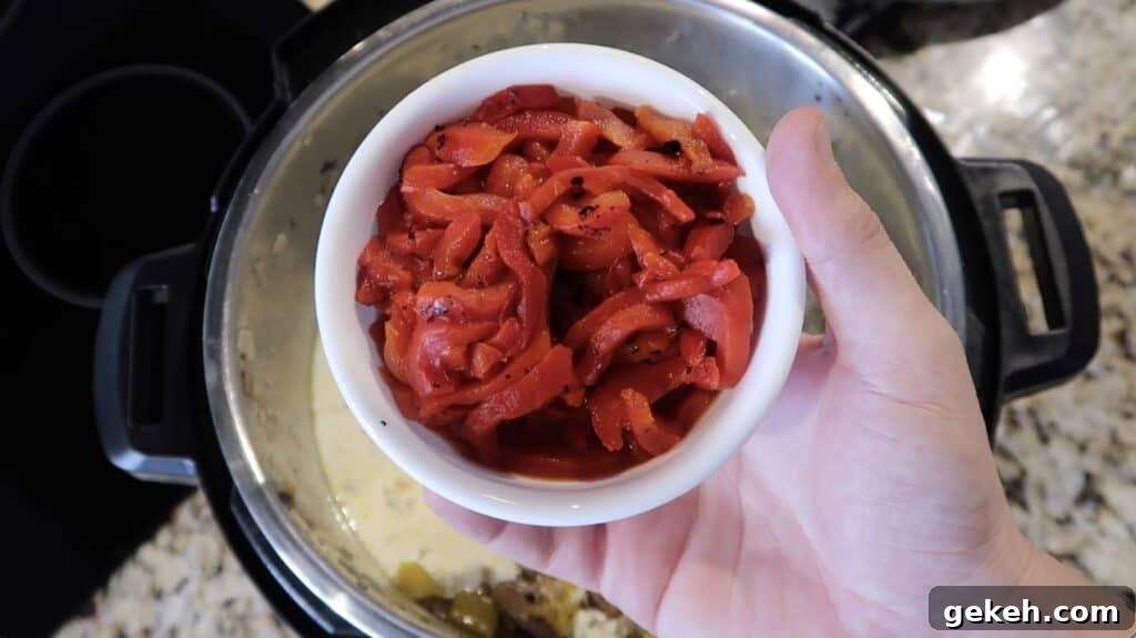 Adding roasted red peppers to pot