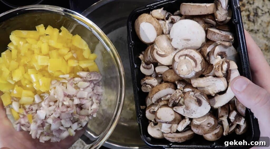 Adding sliced mushrooms and diced shallot and yellow pepper to pot