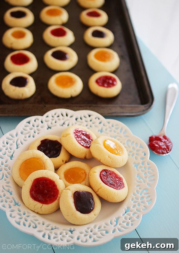 Jam Thumbprint Cookies – Buttery soft cookies with a sweet jam surprise. These simple, delicious jewel-hued cookies are amazing! | thecomfortofcooking.com