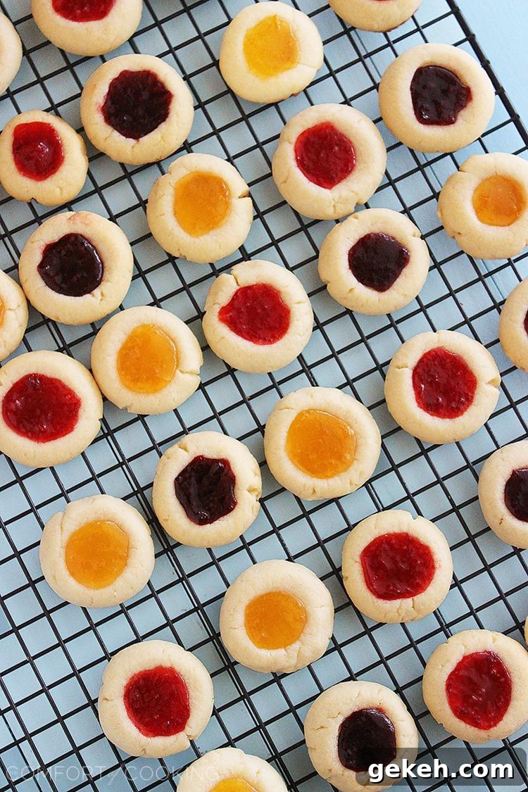 Jam Thumbprint Cookies – Buttery soft cookies with a sweet jam surprise. These simple, delicious jewel-hued cookies are amazing! | thecomfortofcooking.com