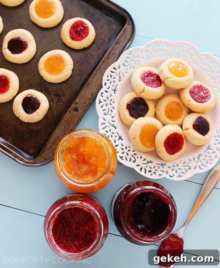 Jam Thumbprint Cookies – Buttery soft cookies with a sweet jam surprise. These simple, delicious jewel-hued cookies are amazing! | thecomfortofcooking.com